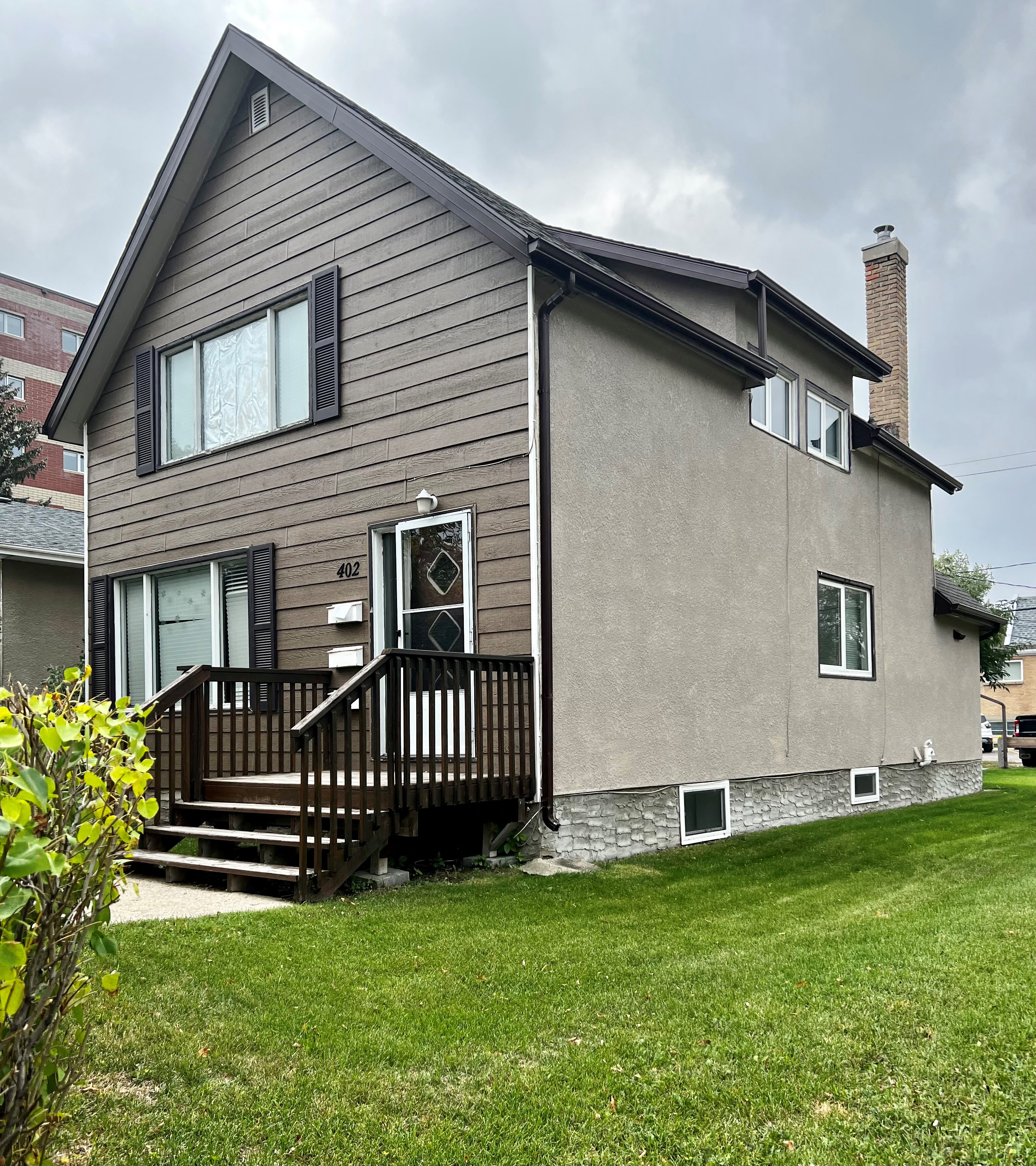 the back of a house with a backdoor and a deck